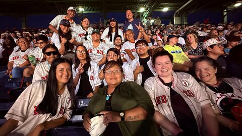 Group photo at a Boston Red Sox game.