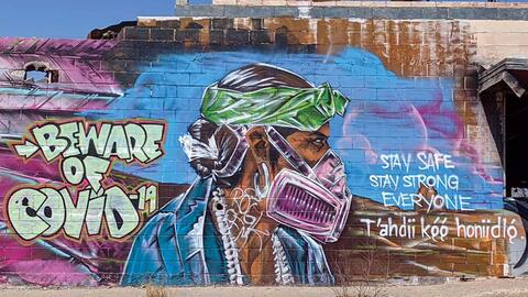 Mural saying "beware of COVID"