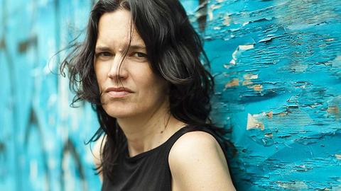Photo of Leanne Betasamosake Simpson in front of a blue background