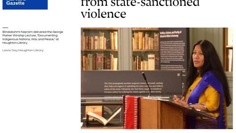 Photo of Binalakshmi Nepram delivering a lecture standing behind a wooden podium